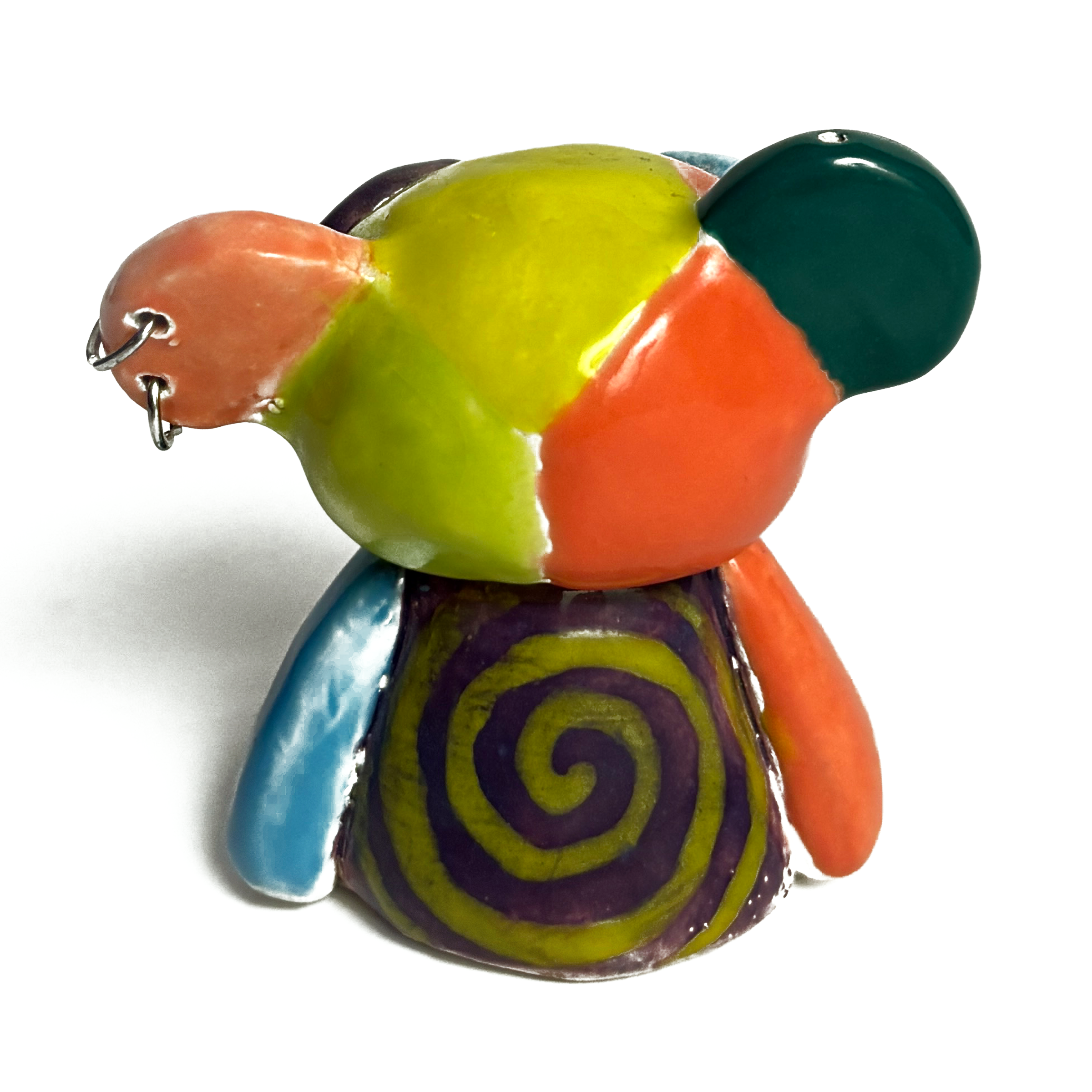 Back of the ceramic bear: lime, orange and teal patches over a purple and lime spiral.